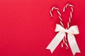 Christmas candy canes, stick and decor on color background. Christmas candy cane heart on an red background Royalty Free Stock Photo