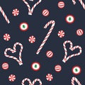 Christmas candy seamless pattern. Flat red and white sweet cane, lollipop, bonbons on blue background.