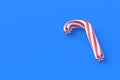 Christmas cane, candy with red stripes on blue background Royalty Free Stock Photo