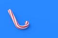 Christmas cane, candy with red stripes on blue background