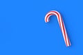 Christmas cane, candy with red stripes on blue background Royalty Free Stock Photo