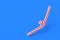 Christmas canes, candy with red stripes on blue background