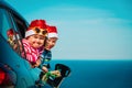 Christmas car travel- happy kids travel in winter at sea Royalty Free Stock Photo