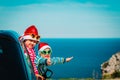 Christmas car travel- happy kids travel in winter at sea Royalty Free Stock Photo