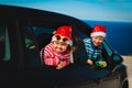 Christmas car travel- happy kids travel in winter at sea Royalty Free Stock Photo