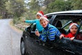 Christmas car travel- happy kids travel in winter Royalty Free Stock Photo