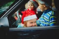 Christmas car travel- happy kids travel by car in winter Royalty Free Stock Photo