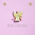 Christmas card with Christmas angel made of straw. Straw Christmas ornament and Christmas greeting on pink background Royalty Free Stock Photo