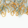 Christmas card background border. Xmas composition with snowy winter fir branches and gold garland isolated on white Royalty Free Stock Photo