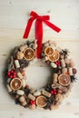 Christmas in a rustic style. Handmade decor. Christmas wreath on the background of old boards. Festive mood.