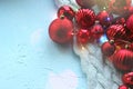 Christmas card. Beautiful Christmas background. Lots of red balls big and small on blue texture background. White snowflakes circl Royalty Free Stock Photo