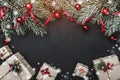 Christmas card. On black stone background. With fir branches adorned with balls and red slack Royalty Free Stock Photo