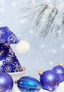 Blue decorated with snowflakes hat Santa Claus, Christmas toys blue balls and snow-covered pine branch. Royalty Free Stock Photo