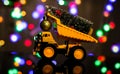 Christmas card. Children`s truck carries a Christmas tree. Bokeh, multicolor color. Merry Christmas concept