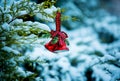 Christmas card. Christmas bells on a snow-covered branch of a juniper. Selective focus Royalty Free Stock Photo