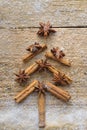 Christmas card with Christmas fir tree made from spices cinnamon sticks, anise star and cane sugar on rustic wooden background Royalty Free Stock Photo