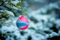 Christmas card. Christmas tree toy on a snow-covered branch of a juniper. Selective focus Royalty Free Stock Photo
