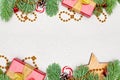Christmas card composition border. Gold garland, green Xmas fir branch, red holly berries, gift and baubles Royalty Free Stock Photo