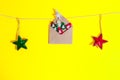 Christmas card concept. Craft envelope with felt christmas trees figures pined by decorative snowflake and glistening stars decor