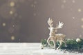 Christmas card conception. Christmas toy deer decoration with christmas tree branch and snow Royalty Free Stock Photo