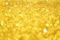 Christmas card with copy space, gold bokeh, sparkles, defocused lights. Festive abstract texture. Glittering background Royalty Free Stock Photo