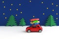 Christmas card with copy space, car with parcels driving through winter landscape at night Royalty Free Stock Photo