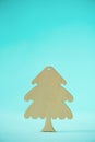 Christmas card with decorative wooden Christmas tree on blue background. New Year holiday concept in minimal style. Copy space Royalty Free Stock Photo