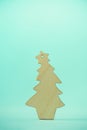 Christmas card with decorative wooden Christmas tree on blue background. New Year holiday concept in minimal style. Copy space Royalty Free Stock Photo