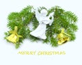 Christmas card with fir branches decorated with bells and an angel