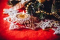 Christmas card with fir tree branch decorated with golden baubles, garlands and vintage snowflakes on a red background. Royalty Free Stock Photo