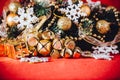 Christmas card with fir tree branch decorated with golden baubles, garlands and vintage snowflakes on a red background. Royalty Free Stock Photo