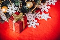 Christmas card with fir tree branch decorated with golden baubles, garlands and vintage snowflakes on a red background. Royalty Free Stock Photo