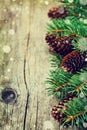 Christmas card of fir tree and conifer cone on rustic wooden background Royalty Free Stock Photo