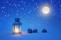 Christmas card in the form of a lantern, moon, balls, stars on a blue background in the snow Royalty Free Stock Photo