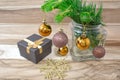 Christmas card, gift box and fir branches with Christmas balls and snowflake on wooden background. Royalty Free Stock Photo