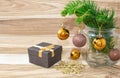 Christmas card, gift box and fir branches with Christmas balls and snowflake on wooden background. Royalty Free Stock Photo