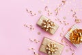 Christmas card. Golden gift or present boxes and star confetti on pink background top view. Flat lay Royalty Free Stock Photo