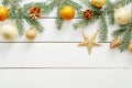 Christmas card with golden ornaments, balls, star, fir tree branches, pine cones on wooden white background. Flat lay Christmas Royalty Free Stock Photo