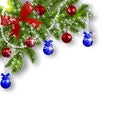 Christmas card. Green branches of a Christmas tree with blue, red balls and ribbon on a white background. Corner with Royalty Free Stock Photo