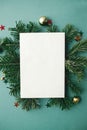 Christmas card mock up. Modern greeting card flat lay with stylish christmas decorations and fir branches on green background. Royalty Free Stock Photo