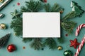 Christmas card mock up. Modern greeting card flat lay with stylish christmas decorations and fir branches on green background. Royalty Free Stock Photo