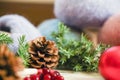 Christmas card needle, a crochet hook and fluffy thread with Christmas decorations and a candle