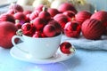 Christmas card, new year. Red balls for the Christmas tree poured into a white Cup . Royalty Free Stock Photo