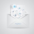 Christmas card with paper snowflakes and Christmas trees inside open envelope. Paper elements in blue style Royalty Free Stock Photo