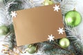 Christmas card : place for text on a silver-brown background with white snowflakes, green Christmas balls and festive tinsel, top Royalty Free Stock Photo