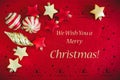 Christmas Card Red background with golden decorations, Balls and Stars, and Wishing Text Royalty Free Stock Photo