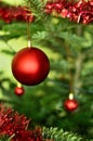 Red Christmas Globe with a part of decorated Christmas Tree on Background Royalty Free Stock Photo