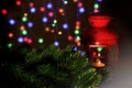 Christmas card. Christmas red glowing lantern with decorated evergreen tree on dark background. Fog Royalty Free Stock Photo