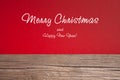 Christmas card, red taxtured paper on wooden background