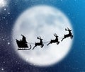 Christmas card with santa claus, reindeer, sleigh, gift and christmas tree on the background of the big moon in the night Royalty Free Stock Photo
